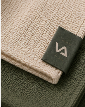 VAVABUY woven label on hotel linen — fabric texture detail